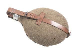 M31 canteen marked WWE 37 with brown straps and roller buckle
