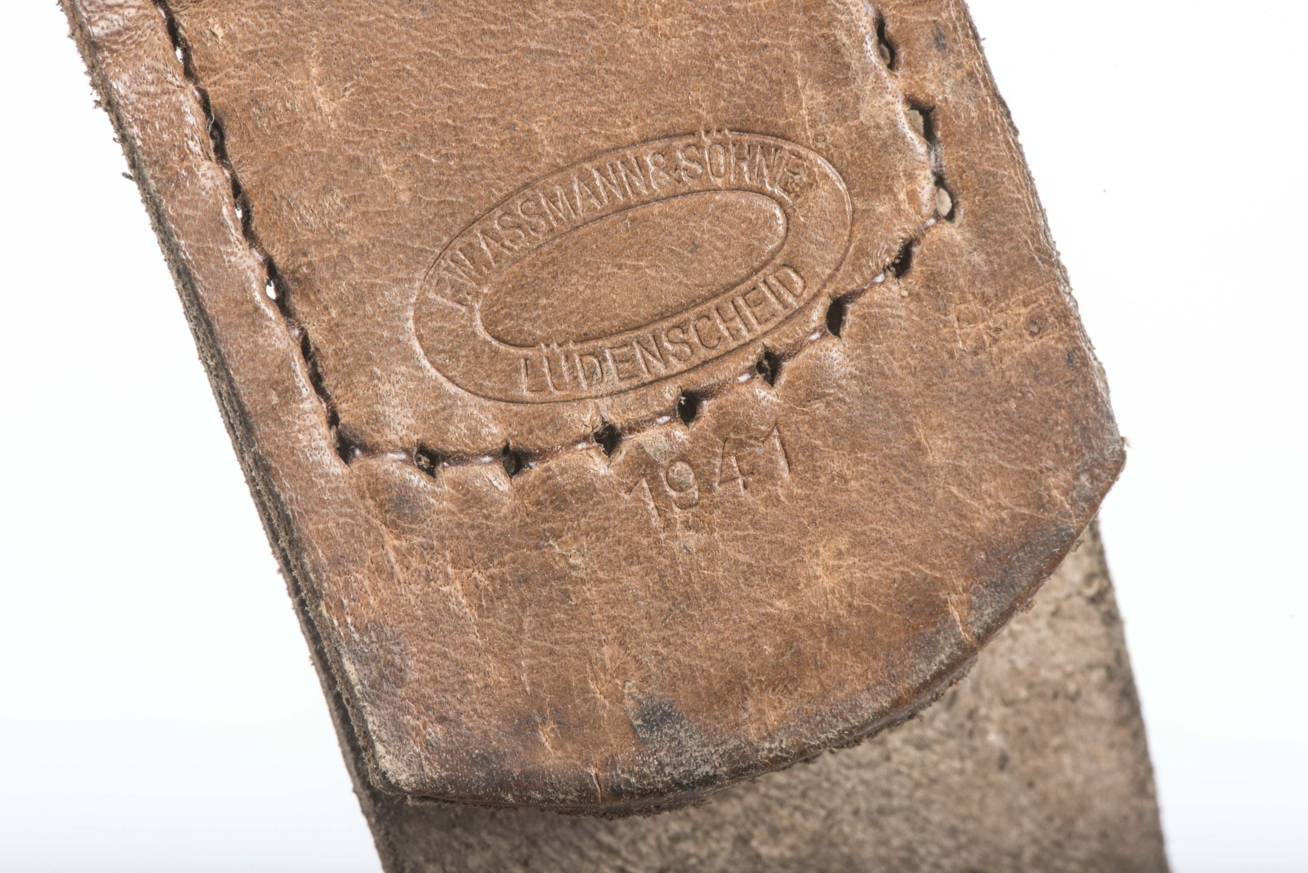 Leather belt buckle tab marked F.W. Assmann & Söhne, Lüdenscheid 1942