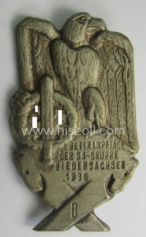 Commemorative, tin-based SA- (ie. 'Sturmabteilungen'-) related 'tinnie', being a non-maker-marked- and 'hollow-back' example depicting an eagle-device and SA-sports'-badge and the text: 'SA-Wettkampftage der SA-Gruppe Niedersachsen - 1936'
