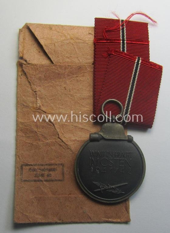 Fully matching medal-set: 'Winterschlacht im Osten 1941/42' as produced by the: 'Hauptmünzamt - Wien'-company being a clearly maker- (ie. '30'-marked) specimen that came stored in its original 'Zellstoff'-based pouch of issue as found