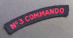 A nice un-issued red on black embroided - regrettably single - Number 3 Commando shoulder title