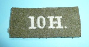 WW1 - '10H' - 10th Royal Hussars (PoW's) Woven White on Khaki Cloth Slip On Shoulder Title