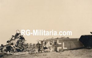 Original WW2 German Photo - German soldier on Rotterdam airfield Waalhaven with a destroyed Junkers JU 52 airplane, Holland (1940)