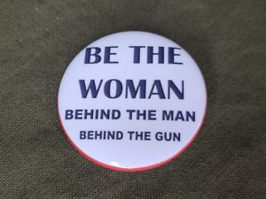 Repro 'Be the Woman Behind the Man Behind the Gun' Pinback Button